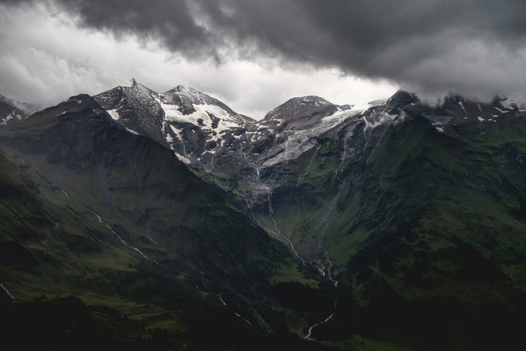 a mountain scene with a valley between, and a path upward.