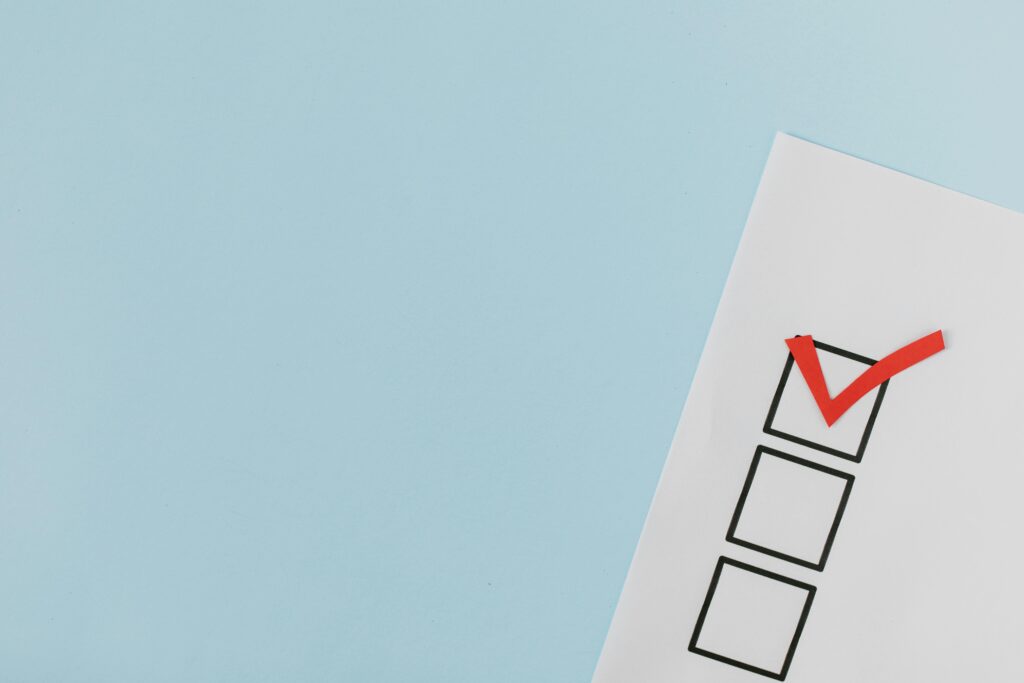 red checkmark on a piece of paper in a black box